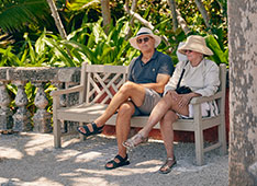 Older couple sitting on a bench. Link to Life Stage Gift Planner Over Age 65 Situations.